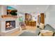 Open-concept living room showcasing a fireplace, breakfast bar, and hardwood floors at 2799 Briarglen Dr, Atlanta, GA 30340