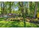 Well-maintained yard with mature plantings, grass, and a chain-link fence surrounding the property at 2799 Briarglen Dr, Atlanta, GA 30340