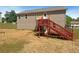 Backyard view featuring a two-story house with a wooden deck, painted stairs, and vinyl siding at 55 Ratliff Dr, Covington, GA 30016