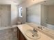 Well-lit bathroom features double vanity and combined tub and shower at 55 Ratliff Dr, Covington, GA 30016
