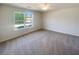 Bright carpeted bedroom with a window at 55 Ratliff Dr, Covington, GA 30016
