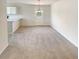 Open-concept dining area with new carpet, a modern light fixture, and natural light at 55 Ratliff Dr, Covington, GA 30016