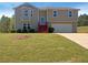 Charming two-story home featuring a bay window, red steps, and an attached two-car garage at 55 Ratliff Dr, Covington, GA 30016