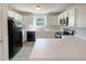 Functional kitchen with white cabinetry, modern appliances, and ample counter space at 55 Ratliff Dr, Covington, GA 30016