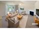 Bright living room with large windows, a fireplace, ceiling fan, and neutral decor at 55 Ratliff Dr, Covington, GA 30016
