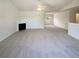 Spacious living room with fireplace and ceiling fan; bathed in natural light at 55 Ratliff Dr, Covington, GA 30016