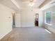 A bright main bedroom offering trey ceilings and a ceiling fan at 55 Ratliff Dr, Covington, GA 30016