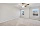 Spacious bedroom featuring neutral walls and carpet, large windows, and abundant natural light at 6108 Marigold Way, Atlanta, GA 30349
