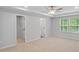 Bright bedroom with ceiling fan, walk-in closet, and natural light from large windows at 6108 Marigold Way, Atlanta, GA 30349