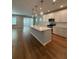 Open-concept kitchen boasts white cabinets, a large island, and stainless steel appliances at 6108 Marigold Way, Atlanta, GA 30349