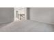Upstairs loft area that is carpeted with natural lighting from a window at 6108 Marigold Way, Atlanta, GA 30349
