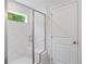 Elegant shower with marble tiling, a glass enclosure, and a built-in seat at 6108 Marigold Way, Atlanta, GA 30349