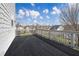 Large black deck with white railings offers a spacious outdoor living area with neighborhood views at 667 Creswell Park, Smyrna, GA 30082