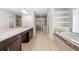 Modern bathroom with double sinks, glass shower, and soaking tub at 667 Creswell Park, Smyrna, GA 30082