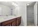 Modern bathroom featuring double sinks with white countertops and cabinets, plus a tub and shower at 667 Creswell Park, Smyrna, GA 30082