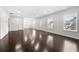 Open-concept living room featuring gleaming wood floors, bright recessed lighting and multiple windows at 667 Creswell Park, Smyrna, GA 30082