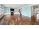 Open-concept living room with hardwood flooring, fireplace, and blue accent wall at 667 Creswell Park, Smyrna, GA 30082