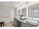 Bathroom featuring dual sinks, granite countertops, vanity mirrors with modern lighting, and tile flooring at 11561 Kimberly Way, Hampton, GA 30228