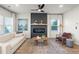 Cozy living room featuring a modern fireplace and plenty of natural light at 11561 Kimberly Way, Hampton, GA 30228