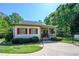 Inviting exterior with covered porch and charming curb appeal in a lush, green setting at 1817 Bedfordshire Dr, Decatur, GA 30033
