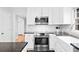 Modern kitchen features stainless steel oven, white cabinetry, and granite countertops at 1817 Bedfordshire Dr, Decatur, GA 30033