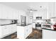 Updated kitchen boasts white cabinets, stainless steel appliances, and a center island at 1817 Bedfordshire Dr, Decatur, GA 30033