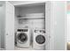 Convenient laundry room with modern appliances and built-in shelving at 1817 Bedfordshire Dr, Decatur, GA 30033