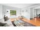 Light-filled living room featuring hardwood floors, a large window, and soft, neutral decor at 1817 Bedfordshire Dr, Decatur, GA 30033