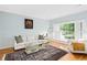 Bright living room with hardwood floors, large windows with shutters, and classic decor at 1817 Bedfordshire Dr, Decatur, GA 30033