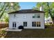 Exterior of home featuring a white back facade with many windows and lush green yard at 235 South St, Buford, GA 30518