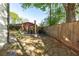Stone patio area with firepit in fenced in backyard at 235 South St, Buford, GA 30518