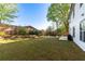 Large, level grassy backyard with privacy fence and a built-in outdoor fire pit at 235 South St, Buford, GA 30518