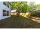 Fenced backyard with grassy lawn, tiered stone-lined beds, and a soccer goal at 235 South St, Buford, GA 30518