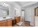 Bathroom featuring double sinks, granite countertops, and a separate shower and toilet area at 235 South St, Buford, GA 30518