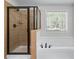 This bathroom has a walk in shower and separate tub with lots of natural light at 235 South St, Buford, GA 30518