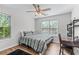 This bedroom features a ceiling fan, a window for natural light and vinyl plank flooring at 235 South St, Buford, GA 30518
