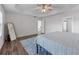 Relaxing primary bedroom with a tray ceiling, ceiling fan, and vinyl plank flooring at 235 South St, Buford, GA 30518