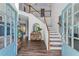 Bright and open foyer with a staircase, hardwood floors, and a view into the living spaces at 235 South St, Buford, GA 30518