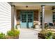Charming front entrance featuring a double door, stone accents, with manicured shrubbery at 235 South St, Buford, GA 30518