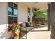 Inviting covered front porch furnished with a comfortable couch, chairs, and a small table with a fan overhead at 235 South St, Buford, GA 30518