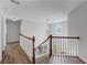 Well-lit hallway with a wooden railing and staircase at 235 South St, Buford, GA 30518