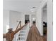Upstairs hallway with wood railing and views into bedrooms and laundry room at 235 South St, Buford, GA 30518