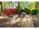 Backyard seating area with gravel, stone, benches, chairs, and a fire pit at 2553 Twilight Vw, Snellville, GA 30078