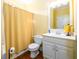 Bright bathroom featuring a white vanity, mirror and a shower with a yellow curtain at 2553 Twilight Vw, Snellville, GA 30078