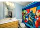 Bathroom featuring a light wood cabinet and sink with a shower curtain featuring superheroes at 2553 Twilight Vw, Snellville, GA 30078