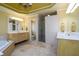 Large bathroom with dual vanities, soaking tub, tiled shower, and neutral tile flooring at 2553 Twilight Vw, Snellville, GA 30078