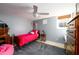 Bedroom with a red bed, grey rug, and a window that provides natural light at 2553 Twilight Vw, Snellville, GA 30078