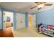 Bedroom with bathroom access, doors to hallway and closet, beige carpet, and blue walls at 2553 Twilight Vw, Snellville, GA 30078