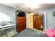 Bedroom with a dark wood dresser, television, vanity, and a grey rug at 2553 Twilight Vw, Snellville, GA 30078
