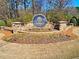 Elegant stone entrance sign for Bright Water, surrounded by lush landscaping and colorful flower beds at 2553 Twilight Vw, Snellville, GA 30078